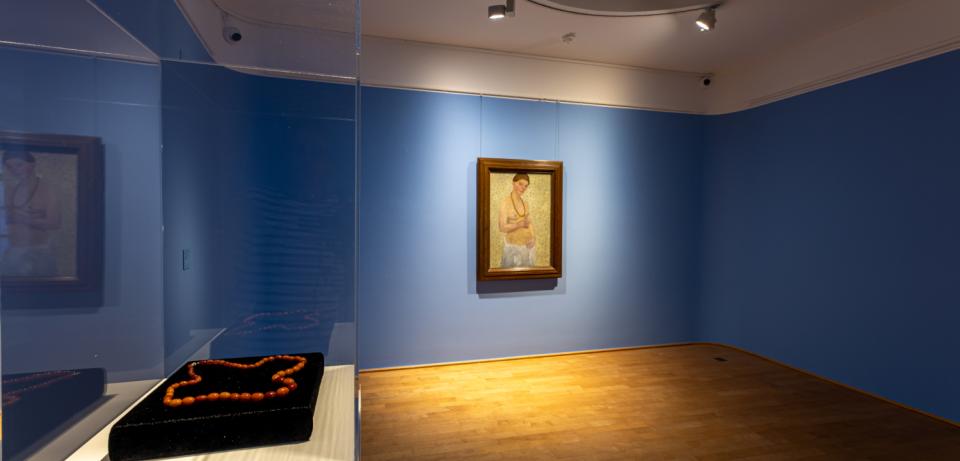 PMB ShortStories2025 Blick in Saal7 mit dem Selbstbildnis am 6.Hochzeitstag und Bernsteinkette 72dpi 1000x1500px Foto Patric Leo Blick in Saal 7 mit dem "Selbstbildnis am 6. Hochzeitstag" (1906) von Paula Modersohn-Becker sowie ihrer original Bernsteinkette © Foto: Patric Leo